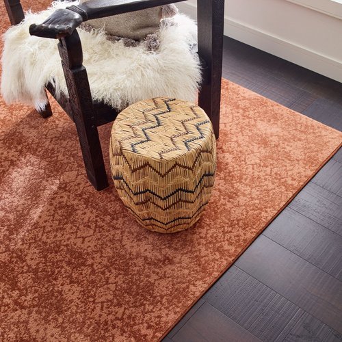black coffee table on orange rug from The Carpet and Drapery Shoppe in Escanaba, MI